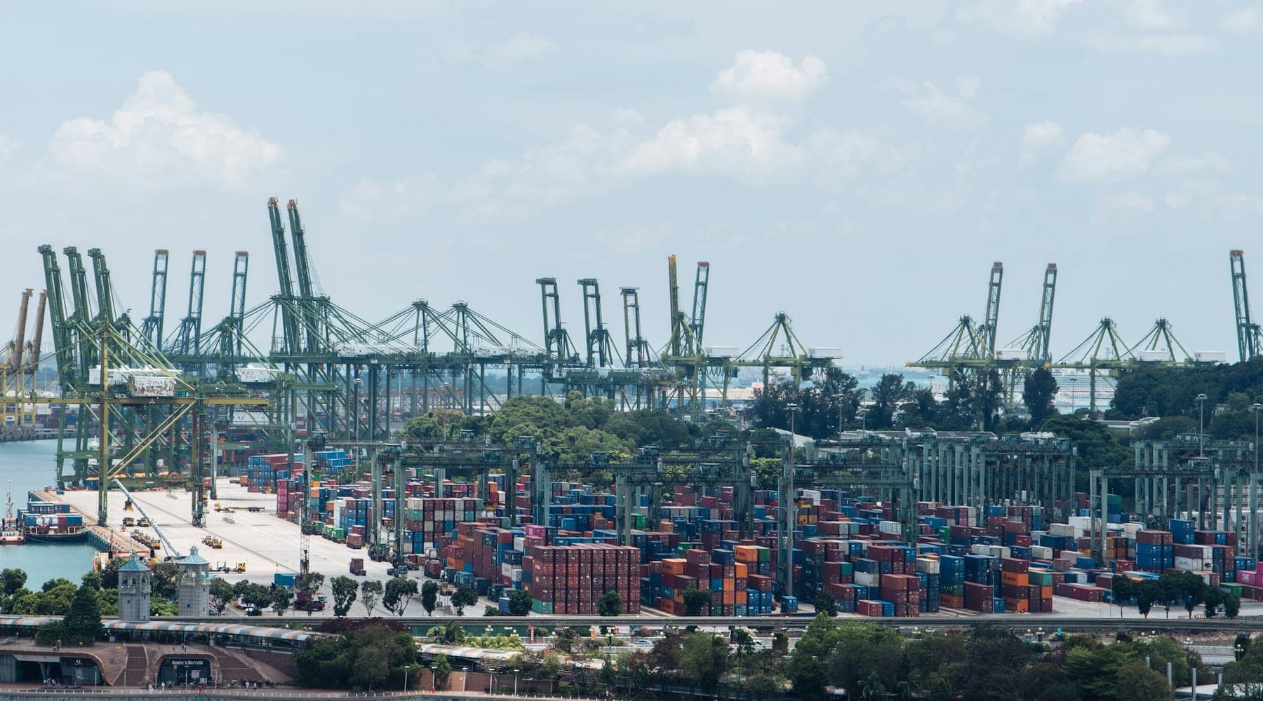 Gantry cranes and stacked freight containers at a container terminal