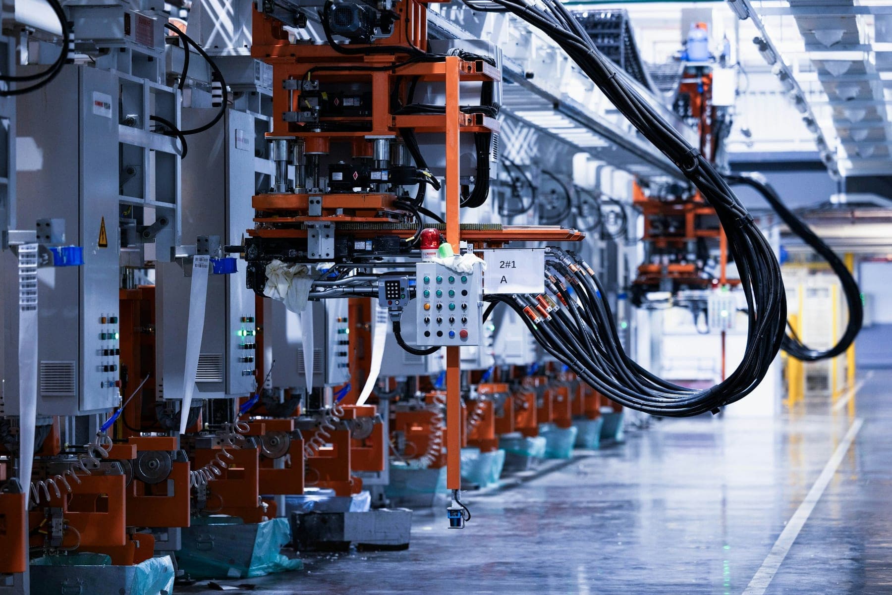 An automated production line of robotic cells and control panels in a manufacturing plant